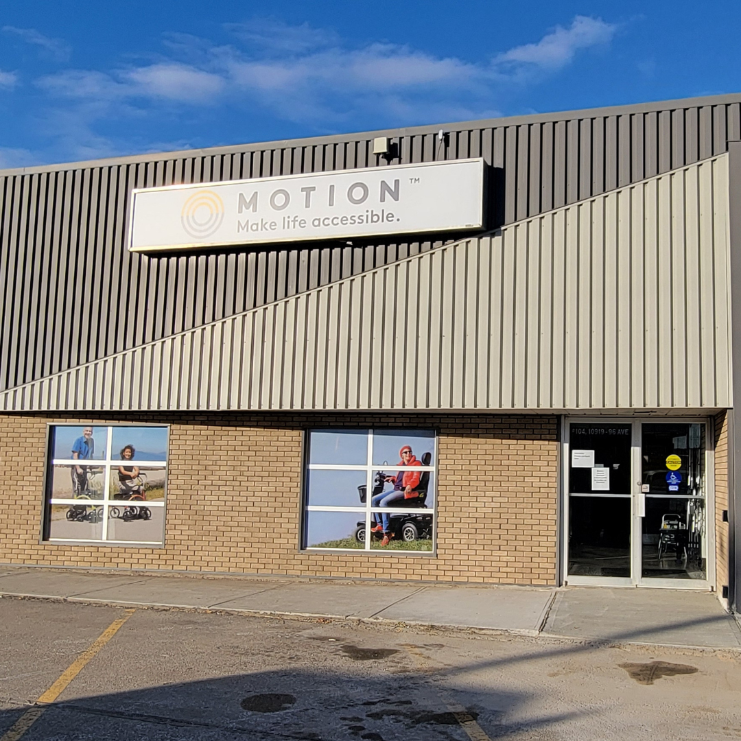 Grande Prairie Exterior View including Motion box sign, front doors and two sets of windows covered with graphics of walkers on left and scooter on right