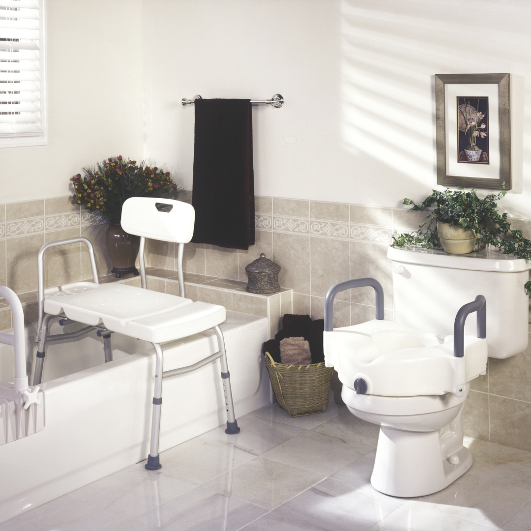 A bath rail, transfer bench and raised toilet seat displayed in a neutral bathroom.